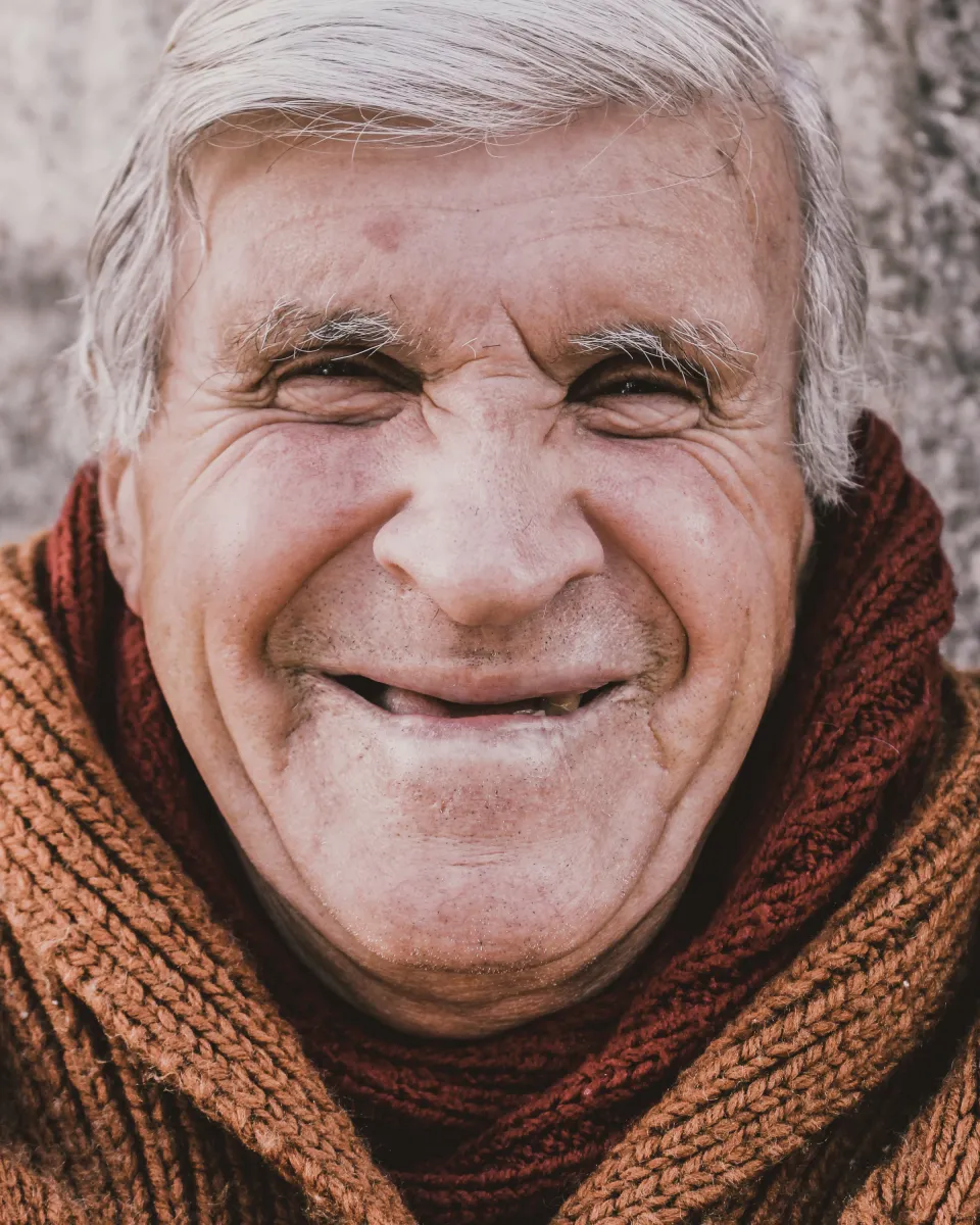 Caregiver in a red scarf smiling, conveying compassion