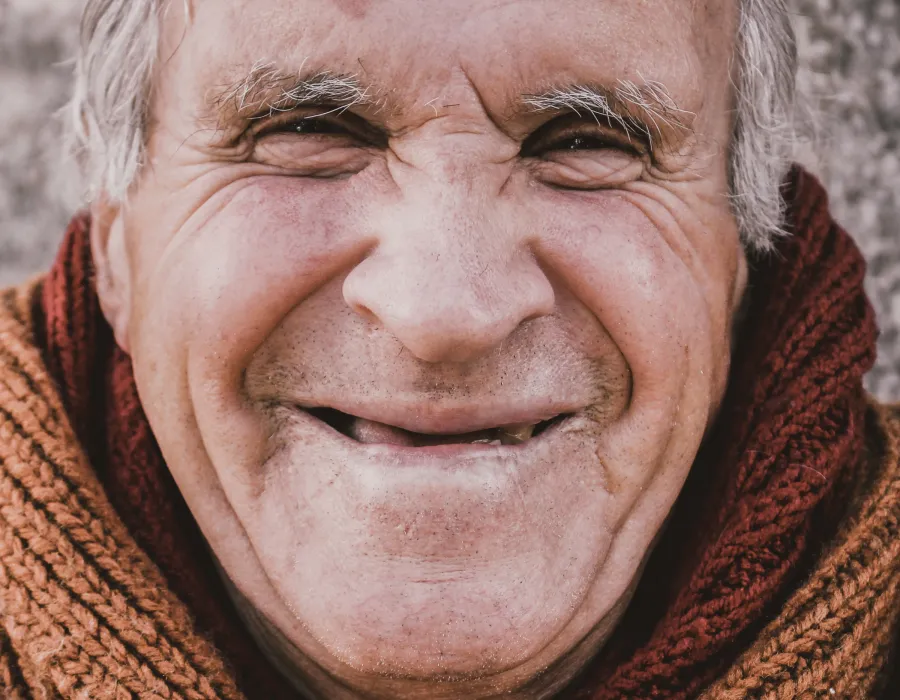 Caregiver in a red scarf smiling, conveying compassion