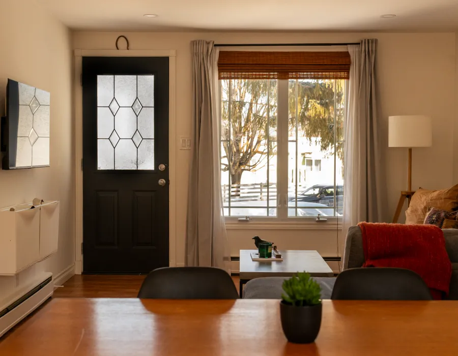 Warm, welcoming living room with a fireplace and large window