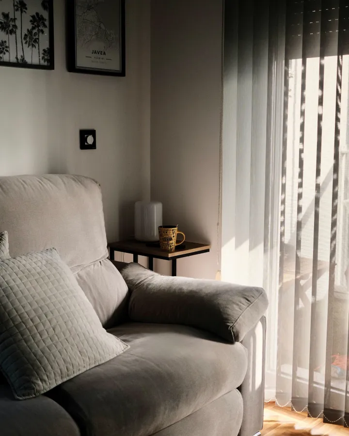 Cozy sofa bathed in afternoon sunlight by a window