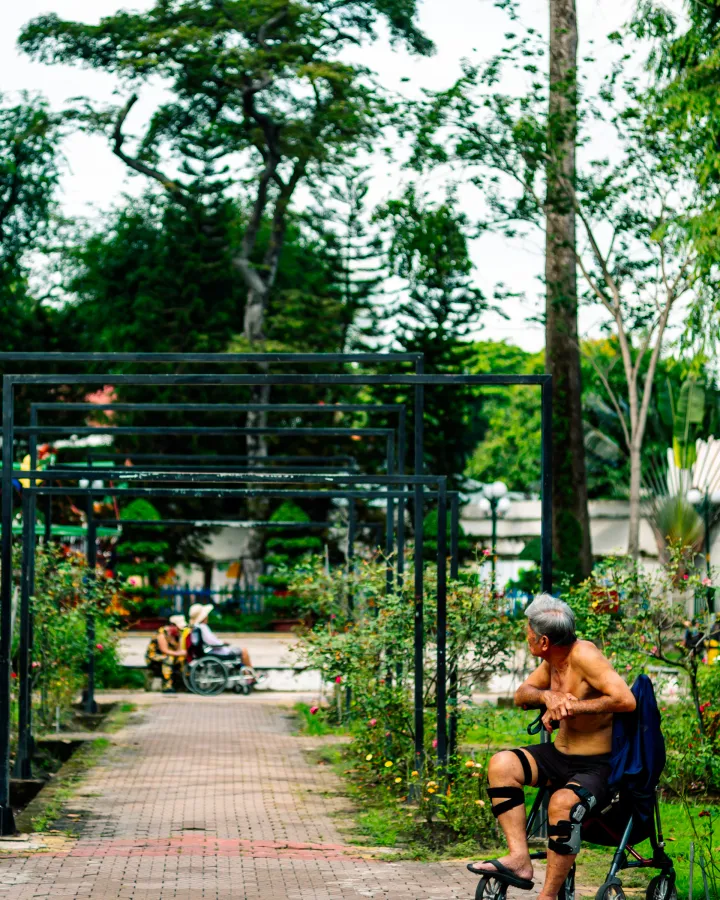 Senior man walking with a mobility walker on an outdoor path